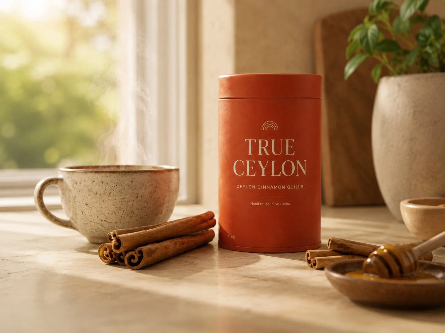 A True Ceylon tin of whole Ceylon cinnamon quills in a warm kitchen with a steaming cup