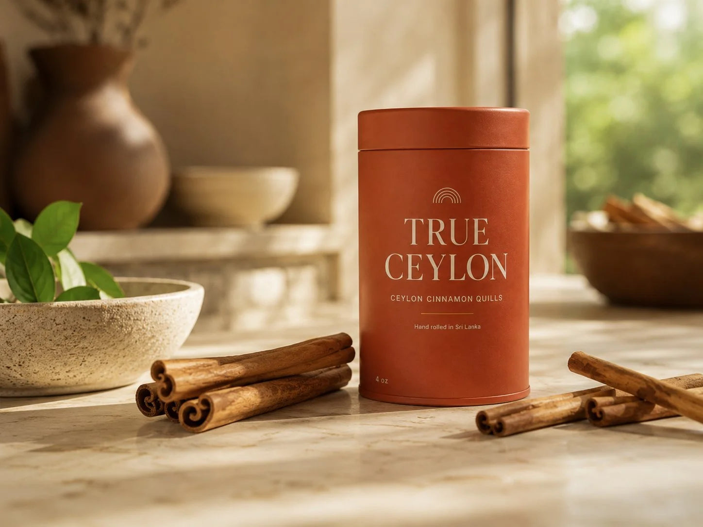 A True Ceylon tin of whole Ceylon cinnamon quills standing on a warm cream kitchen counter